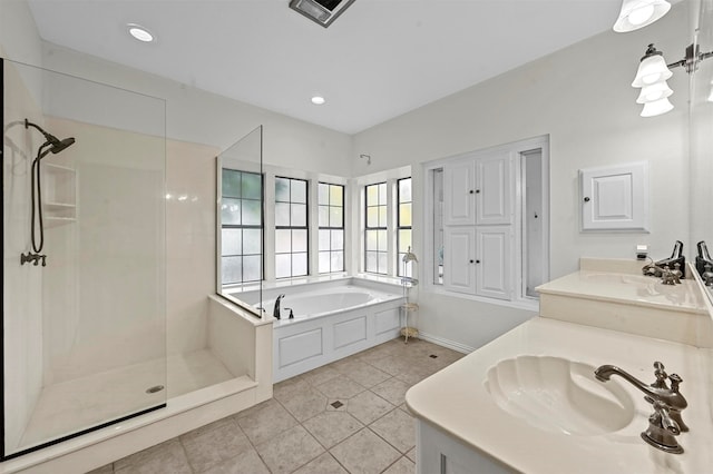 bathroom featuring tile patterned flooring, vanity, and separate shower and tub