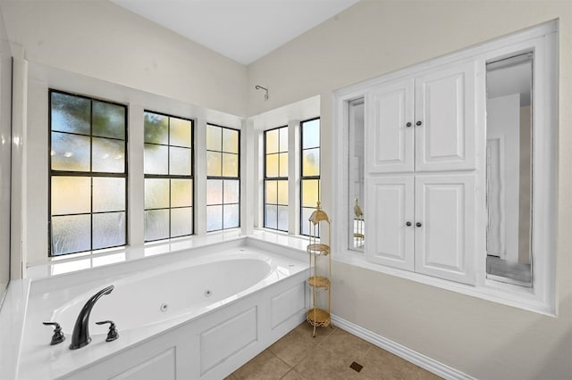 bathroom with tile patterned flooring, plenty of natural light, and a washtub