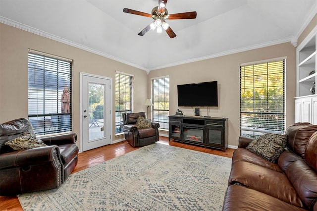 living room featuring hardwood / wood-style floors, ceiling fan, vaulted ceiling, and ornamental molding