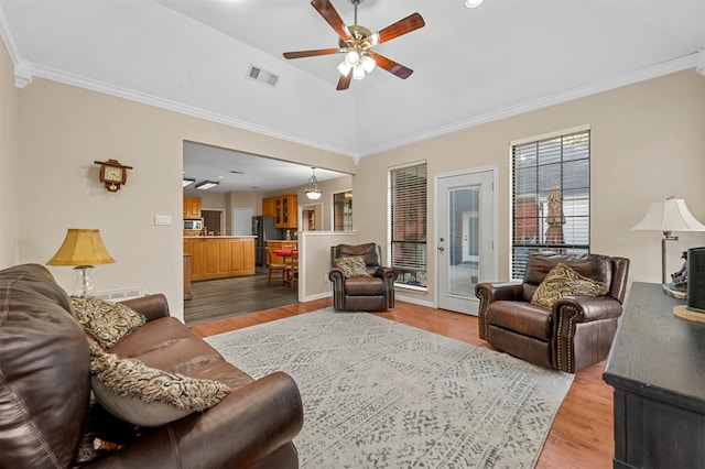 living room with wood-type flooring and ornamental molding