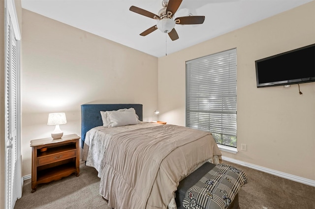 carpeted bedroom featuring ceiling fan and a closet