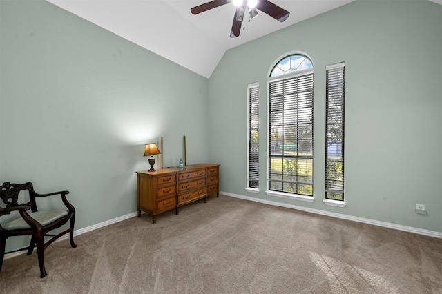 living area featuring light colored carpet, ceiling fan, and vaulted ceiling