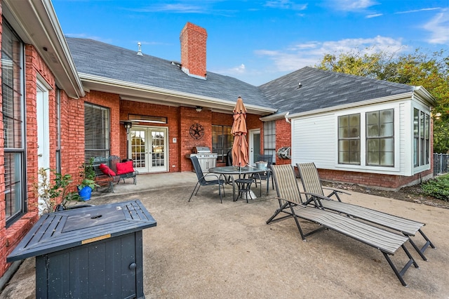 rear view of property with french doors and a patio area