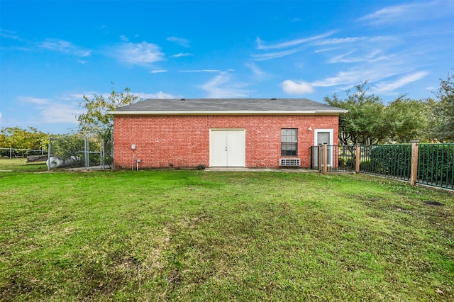 rear view of house featuring a yard