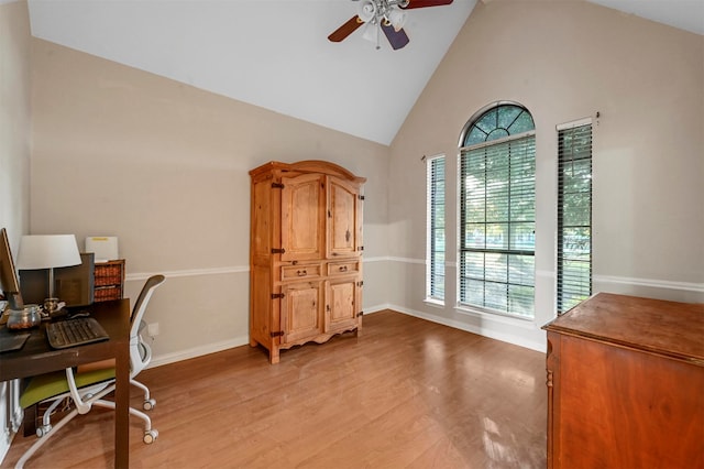 office space featuring high vaulted ceiling, light wood-type flooring, and ceiling fan