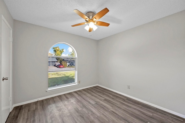 empty room featuring hardwood / wood-style floors, a textured ceiling, and ceiling fan