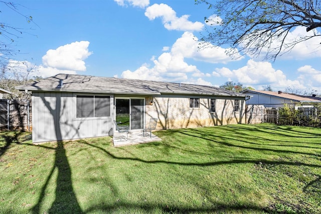 rear view of house featuring a yard