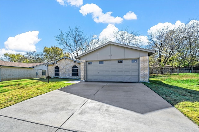 single story home featuring a garage and a front yard