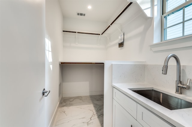 walk in closet featuring sink