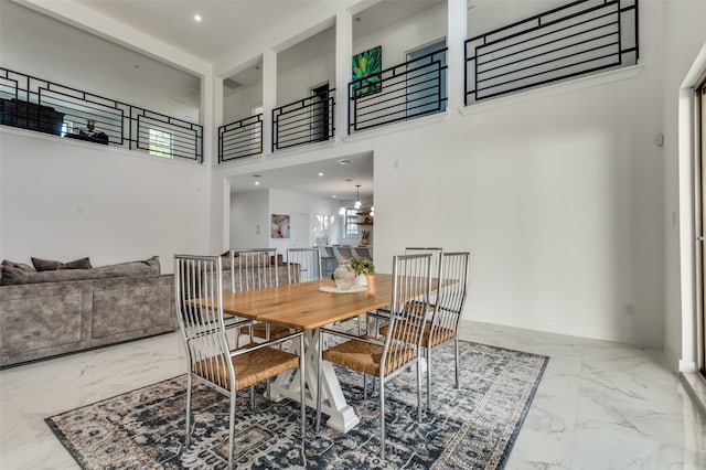 dining area featuring a high ceiling and a chandelier