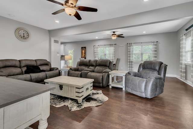 living room with dark wood-type flooring and ceiling fan