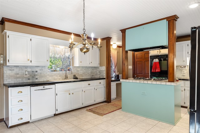 kitchen featuring decorative light fixtures, a center island, sink, white appliances, and white cabinets