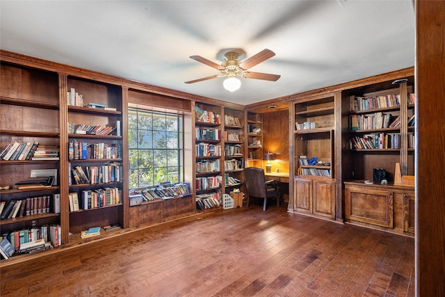 home office featuring dark wood-type flooring, built in features, and ceiling fan