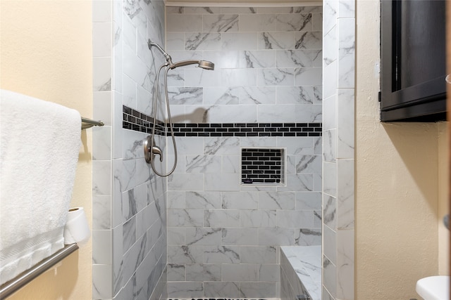 bathroom with a tile shower