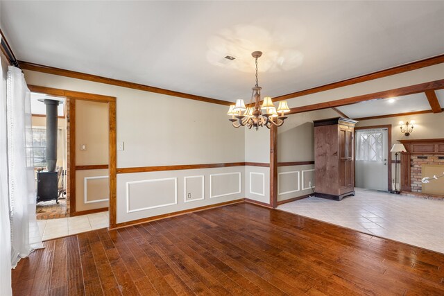 interior space featuring ornamental molding, a chandelier, and light wood-type flooring