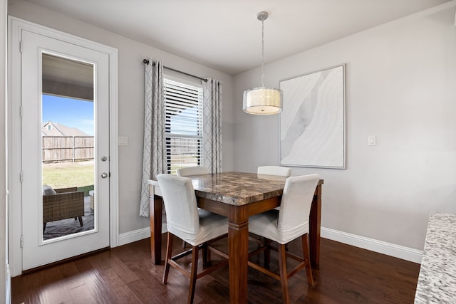 dining area with dark hardwood / wood-style flooring