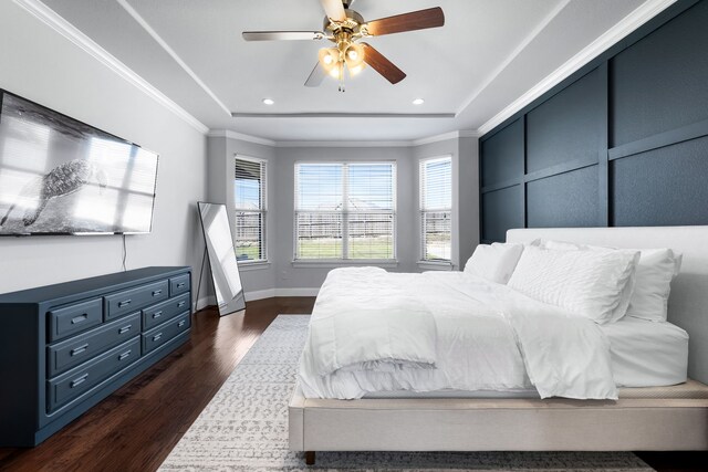 bedroom featuring dark hardwood / wood-style floors, ceiling fan, and crown molding