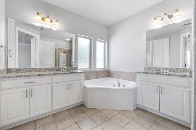 bathroom featuring tile patterned flooring, vanity, and separate shower and tub