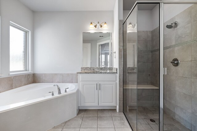 bathroom featuring tile patterned flooring, vanity, and independent shower and bath