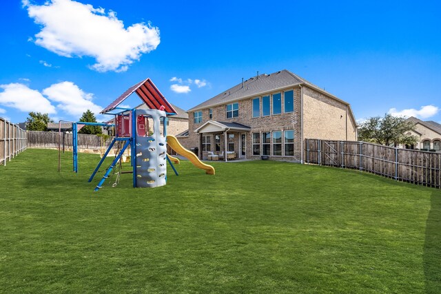 view of playground with a yard