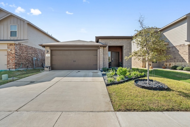 view of front of house with a garage and a front lawn