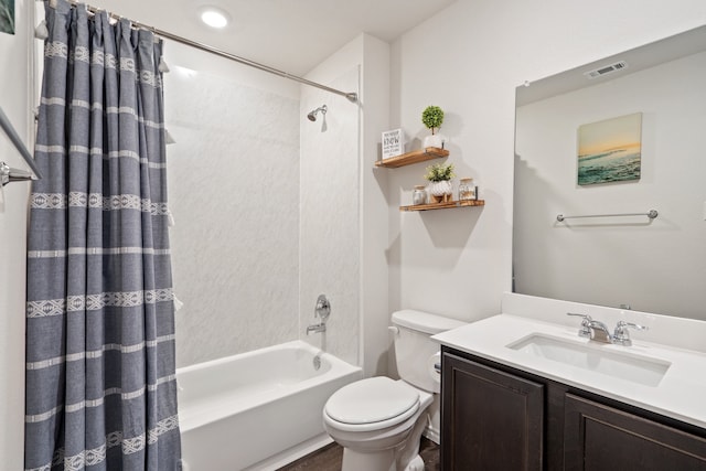 full bathroom with vanity, shower / tub combo, and toilet