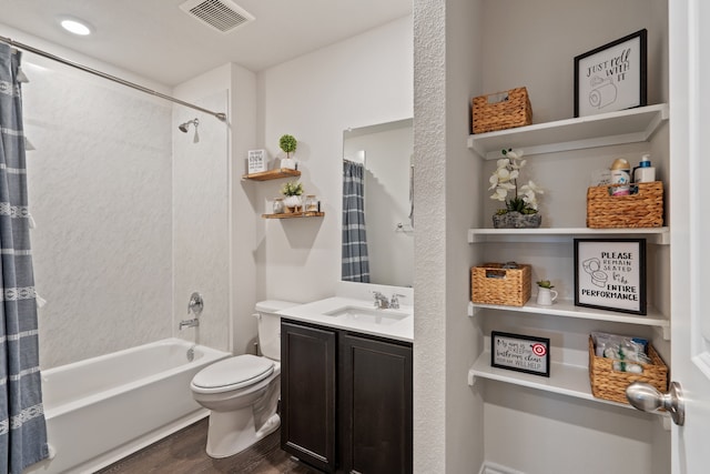 full bathroom featuring hardwood / wood-style floors, shower / bathtub combination with curtain, vanity, and toilet