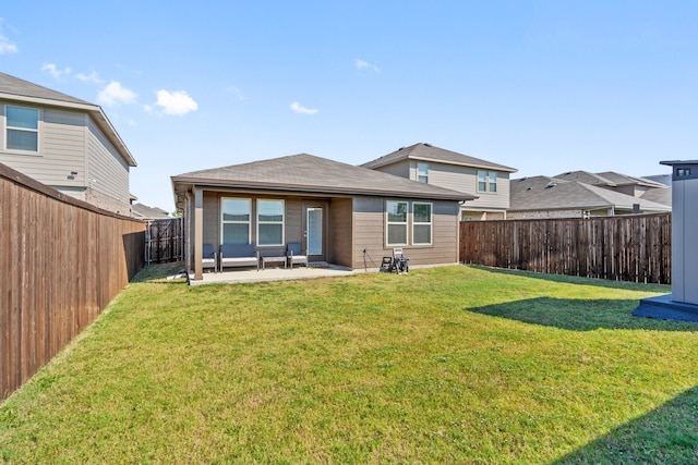 back of house with a yard and a patio area