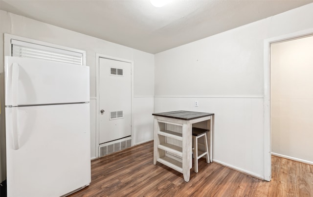 kitchen featuring dark hardwood / wood-style flooring and white refrigerator