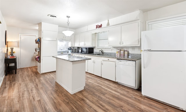 kitchen featuring a kitchen island, white cabinetry, hanging light fixtures, and white appliances