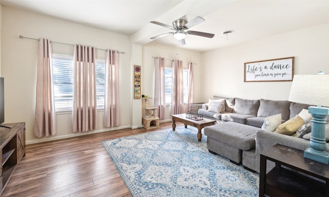 living room featuring dark wood-type flooring and ceiling fan