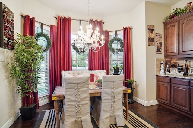 dining space featuring an inviting chandelier and dark hardwood / wood-style floors