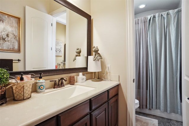 bathroom featuring vanity, toilet, and a shower with shower curtain