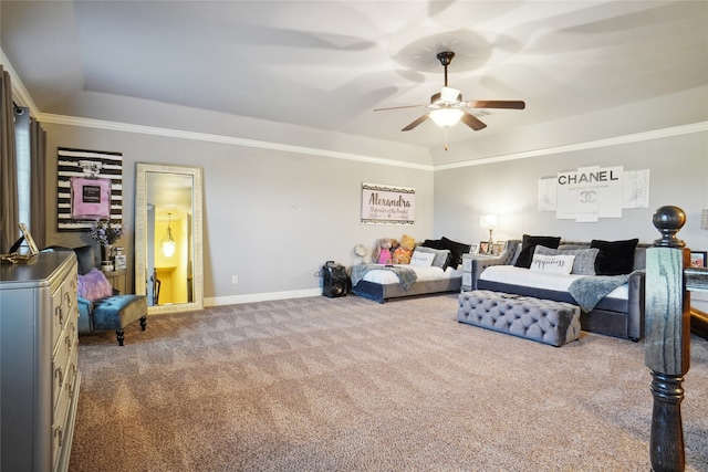 carpeted bedroom with ornamental molding, ceiling fan, and a tray ceiling