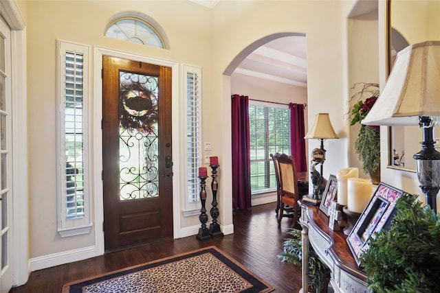 entryway featuring beamed ceiling, dark hardwood / wood-style floors, and ornamental molding