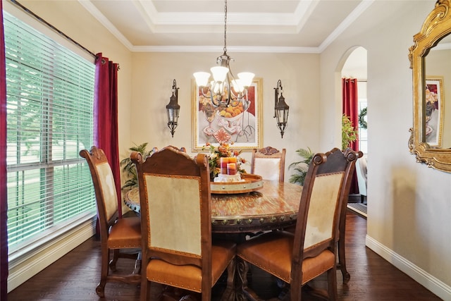 dining area featuring a tray ceiling, plenty of natural light, dark wood-type flooring, and a chandelier