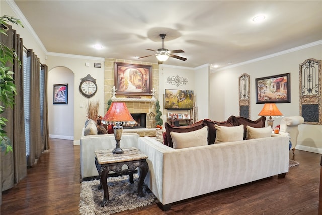 living room featuring ornamental molding, a fireplace, and dark wood-type flooring