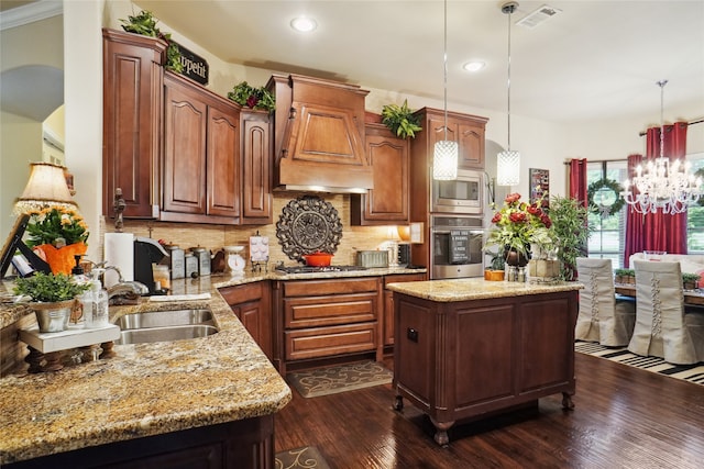 kitchen featuring stainless steel appliances, sink, dark hardwood / wood-style flooring, custom exhaust hood, and decorative light fixtures