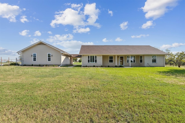 back of property featuring a yard