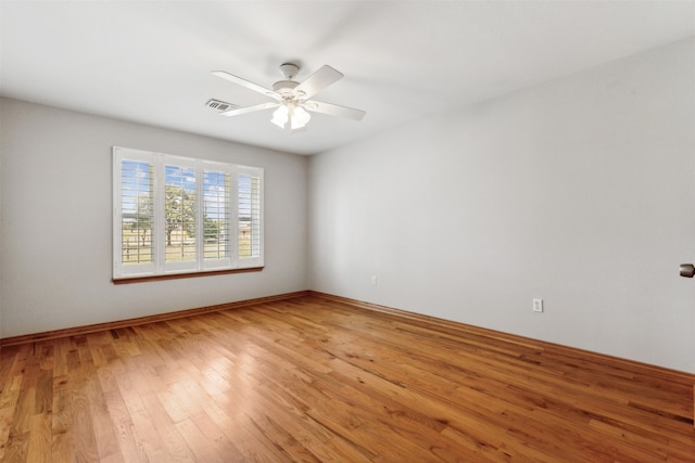 empty room with light hardwood / wood-style flooring and ceiling fan