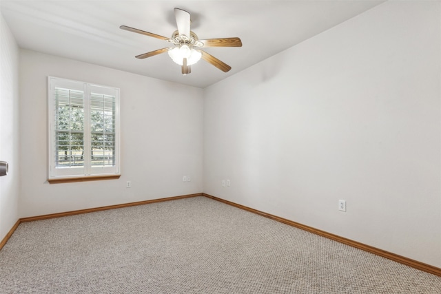 carpeted spare room with ceiling fan