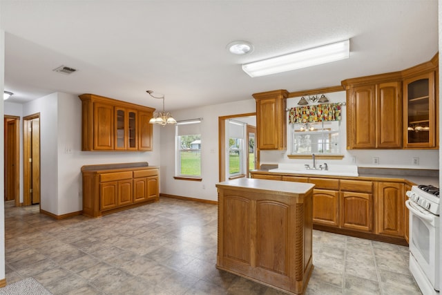 kitchen featuring pendant lighting, sink, a center island, an inviting chandelier, and white range