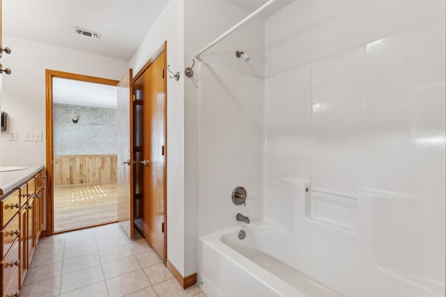 bathroom with vanity, tiled shower / bath combo, and tile patterned floors