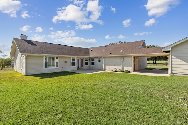 rear view of property featuring a patio and a lawn