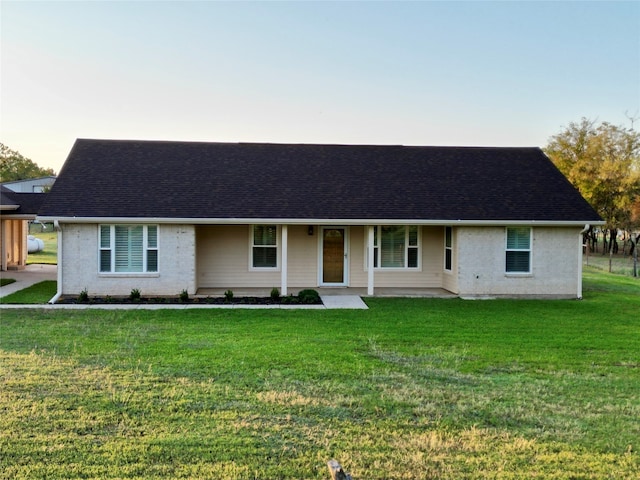 ranch-style home with a front lawn