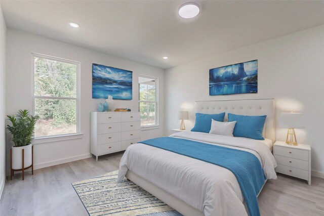 bedroom featuring light wood-type flooring and multiple windows