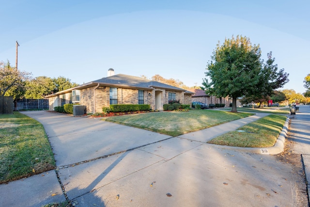 single story home featuring central AC unit and a front lawn