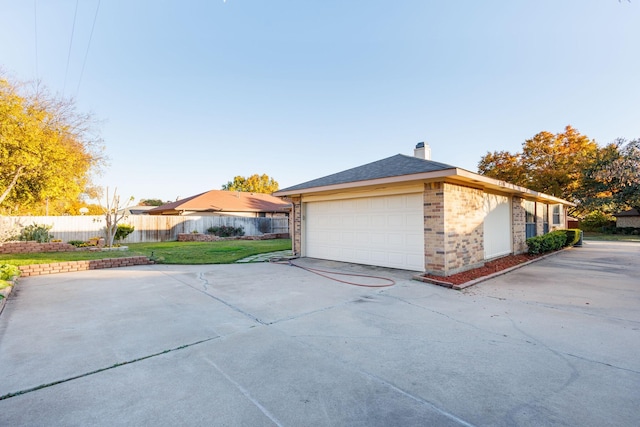 view of home's exterior featuring a lawn and a garage