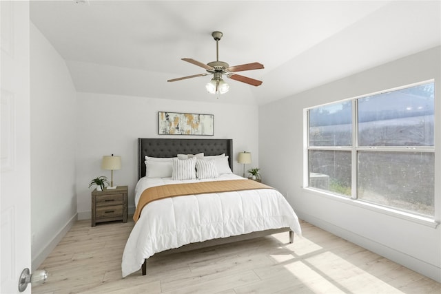 bedroom featuring lofted ceiling, ceiling fan, and light hardwood / wood-style floors