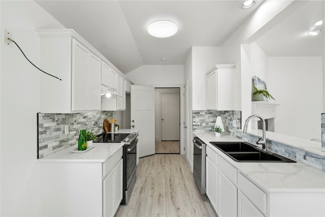 kitchen featuring stainless steel appliances, sink, decorative backsplash, and white cabinetry